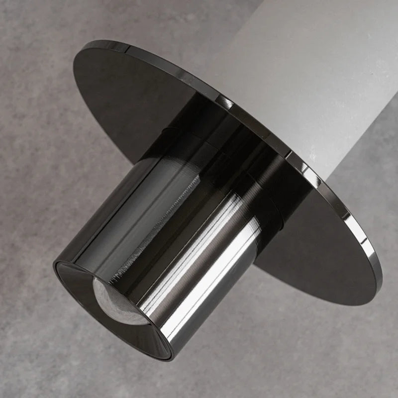 Close-up of black metal and frosted alabaster tube pendant light shade