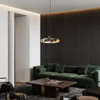 Marble pendant light over living room sofa; black canopy and gray-amber veined disc