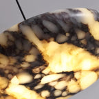 Close-up of gray, black, and amber marble disc shade on a pendant light