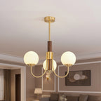 Gold and dark brown globe chandelier with multiple round glass bulb shades and curved arms
