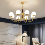 Dark brown stem and gold curved arms globe chandelier with multiple round glass bulb shades