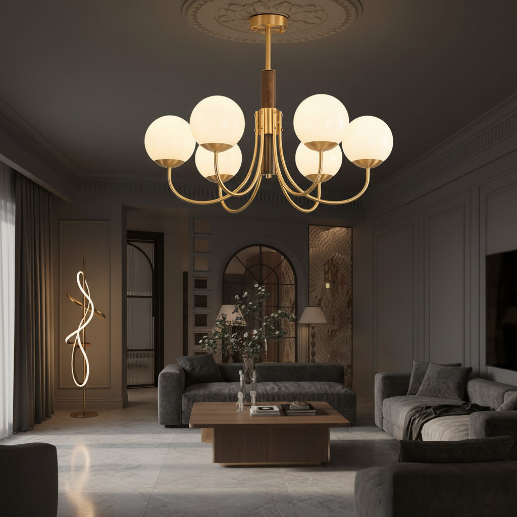 Gold globe chandelier with dark brown center stem and multiple round glass shades on curved arms