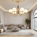 Gold globe chandelier with dark brown central stem and multiple round glass bulb shades