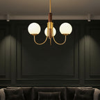 Gold globe chandelier with dark brown vertical stem and multiple round glass bulb shades
