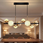 Mid-century globe chandelier with textured glass balls, black bar and brass arms