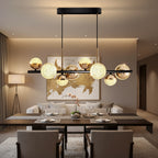 Globe chandelier with textured glass balls, black bar, and brass hanging frame