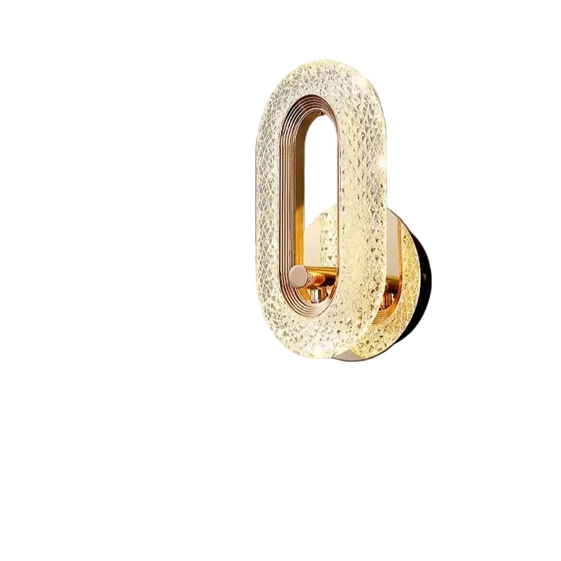 Gold textured oval wall sconce with curved backplate and warm brass interior