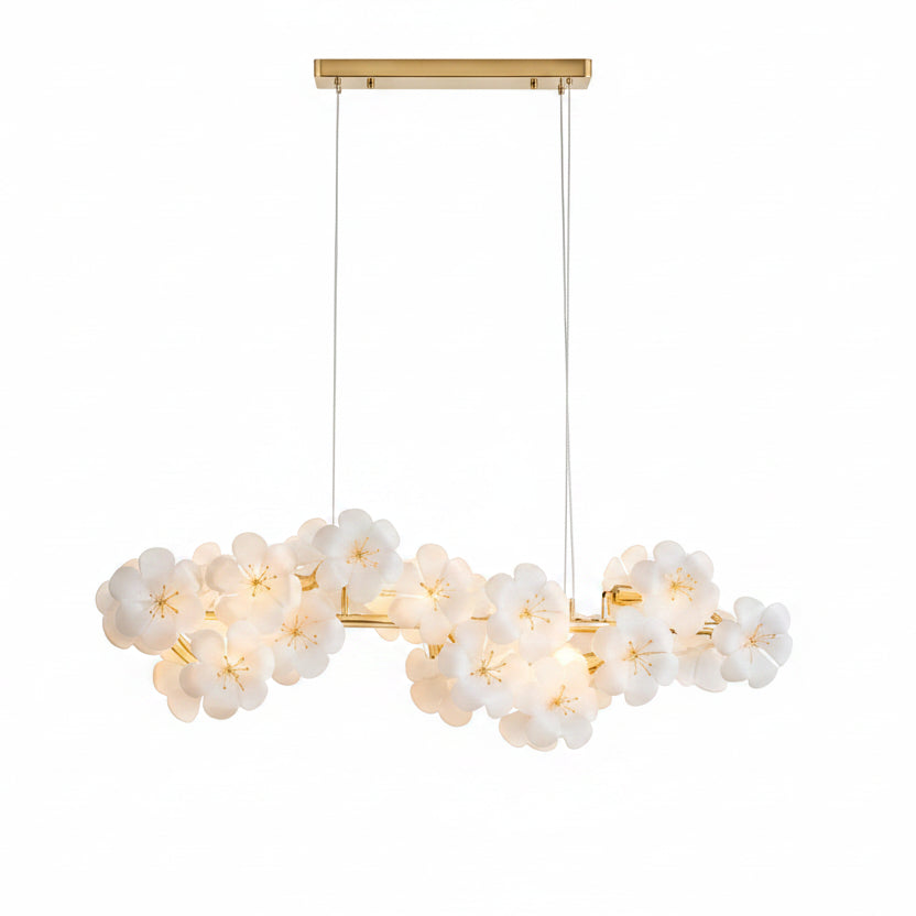 White floral blossom linear chandelier with gold bar hardware and hanging cord