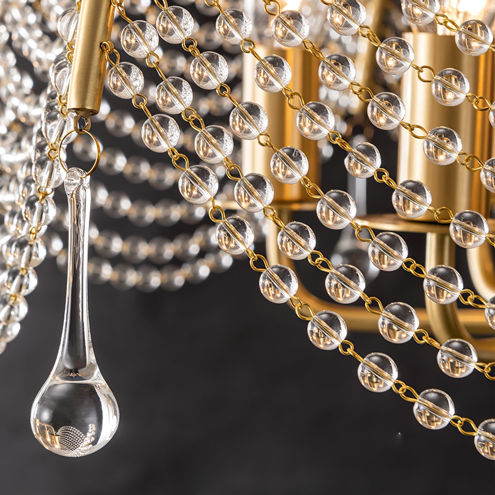Umbrella-style crystal chandelier with teardrop glass crystals and gold chain links