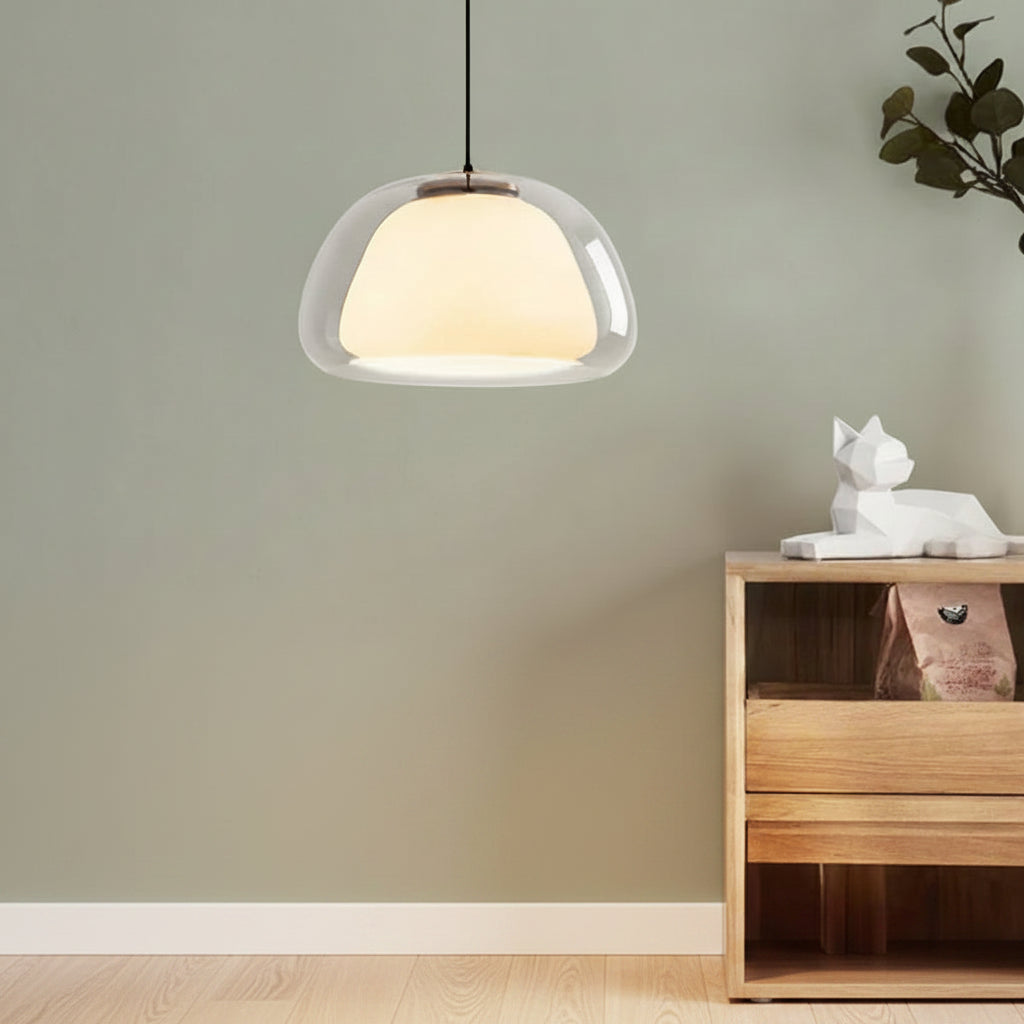 Nordic tinted glass pendant light with clear glass shade and warm glowing diffuser