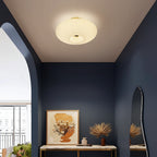 White fluted saucer ceiling light with a ribbed diffuser and round recessed center