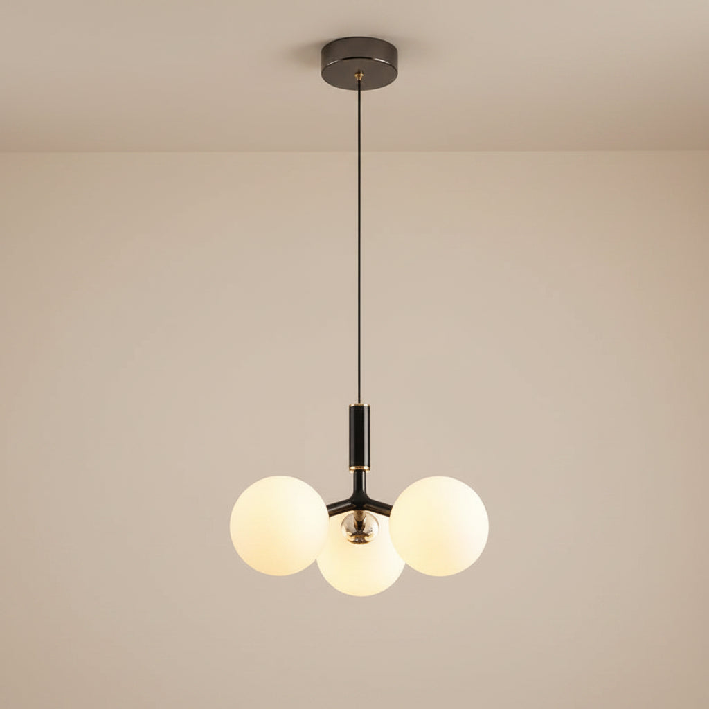 Globe pendant light with three white glass spheres, black connector bar, black canopy