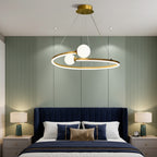 Gold ring LED chandelier with three white globe lights suspended in a bedroom ceiling