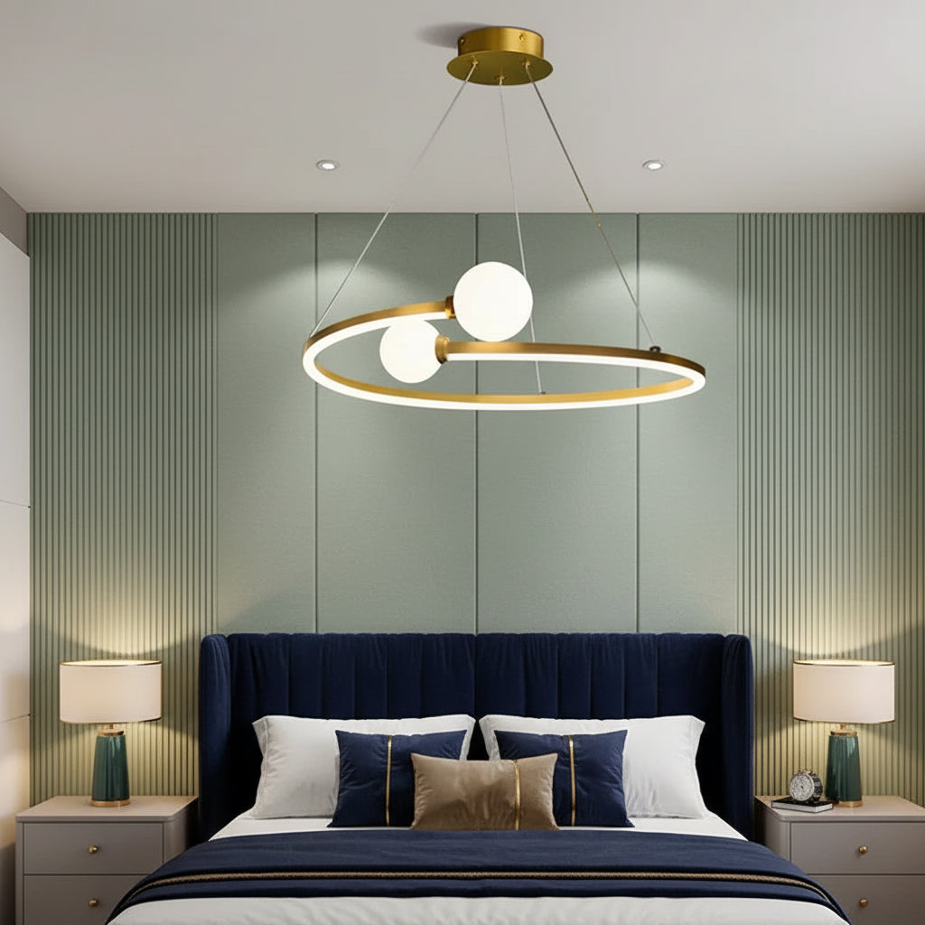Gold ring LED chandelier with three white globe lights suspended in a bedroom ceiling