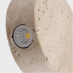 Round travertine disc pendant light close-up showing LED module inside
