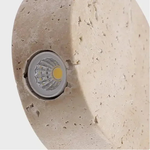 Round travertine disc pendant light close-up showing LED module inside