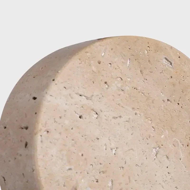 Close-up of round travertine disc pendant light with textured stone surface