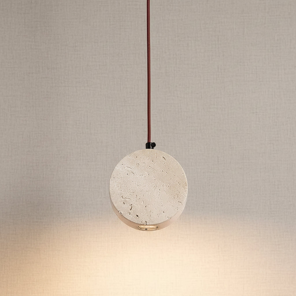 Round travertine disc pendant light with copper cord and warm downlight