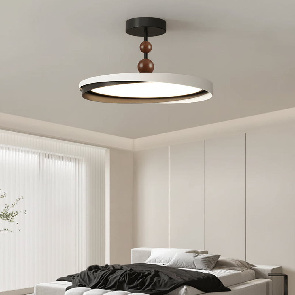 Geometric ceiling light fixture with black round mount, white outer ring, and brown bead stem