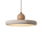 Travertine dome pendant light with wood knob and circular shade, warm glow