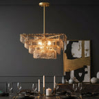 Layered square glass chandelier with gold frame, warm lit bulbs, hanging stem
