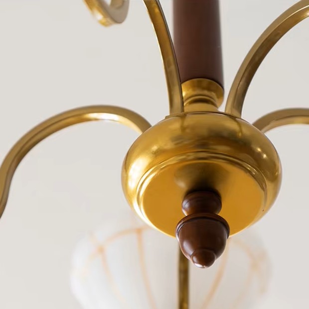 Brass chandelier center with rounded canopy and brown finial, curved arms