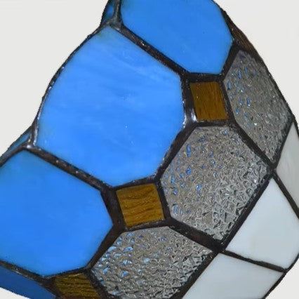 Close-up of blue stained-glass shade panels with black metal framing
