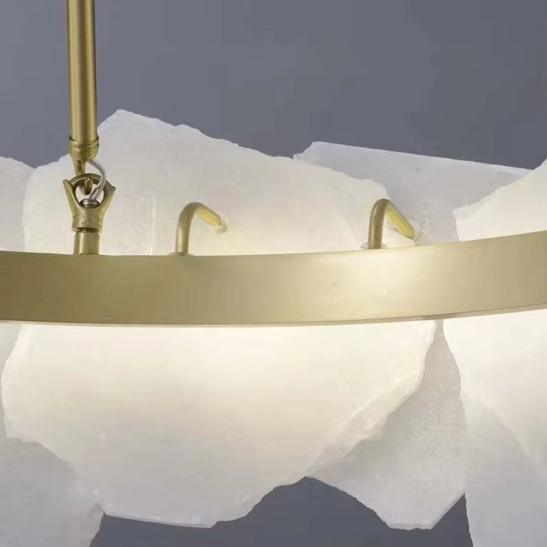 Close-up of brass stem and white tiered drum disc glass shade panels
