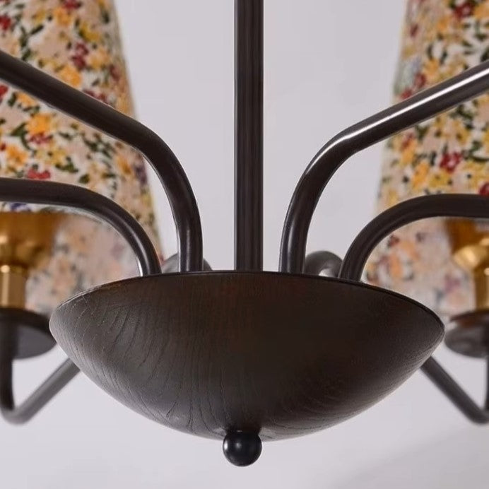 Close-up of the dark metal central bowl and surrounding curved arms with shades