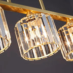 Close-up of gold chandelier hardware with clear faceted cylindrical glass shades