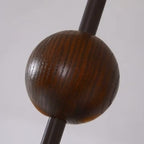 Close-up of the dark brown wood-style sphere finial on the hanging chandelier