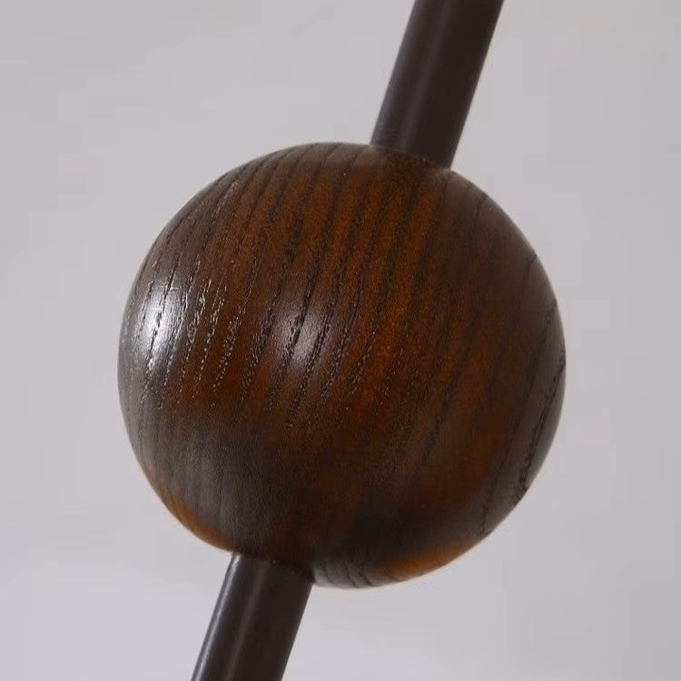 Close-up of the dark brown wood-style sphere finial on the hanging chandelier