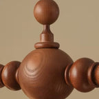 Close-up of walnut spindle-ball wood finials for a globe chandelier