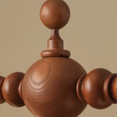 Close-up of walnut spindle-ball wood finials for a globe chandelier