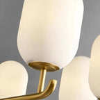 Close-up frosted glass shade on gold-toned metal arm, upward lighting fixture