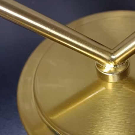 Gold-tone twin wall light with arched arms and round backplate detail