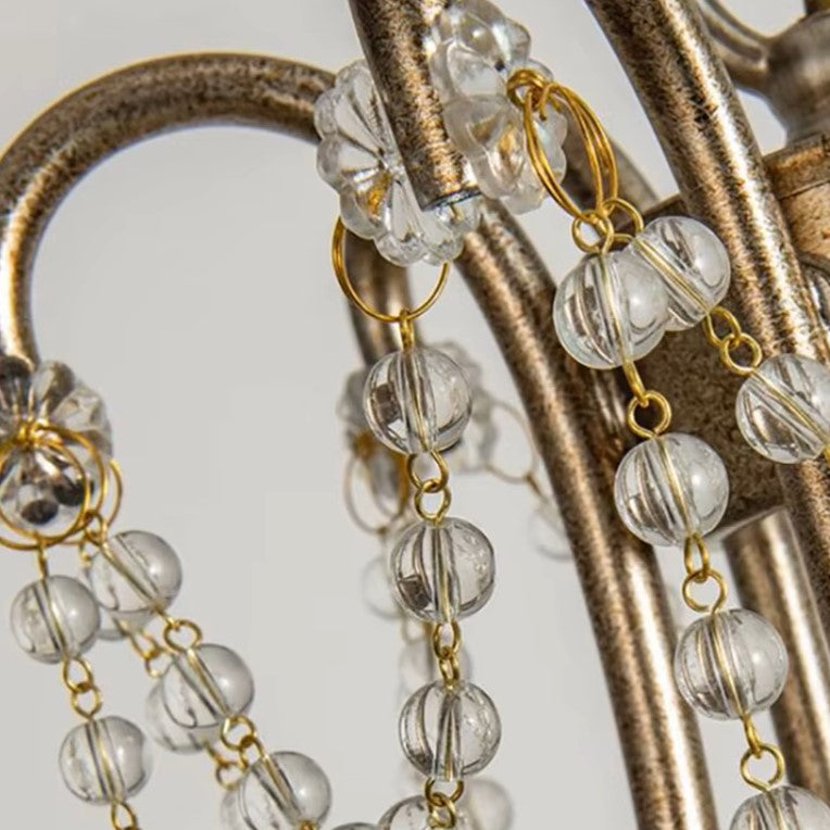 Close-up of gold-tone links and clear teardrop beads on hanging chandelier chain