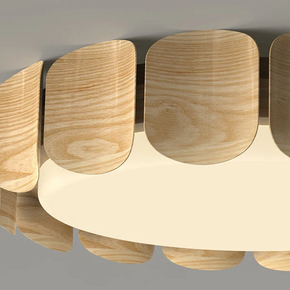 Close-up of scalloped wood panels around a circular ceiling light diffuser