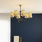 Multi-arm chandelier with conical floral shades and dark metal arms with brass accents