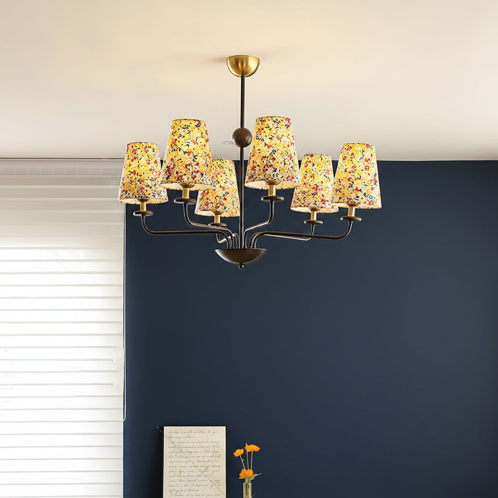 Multi-arm chandelier with conical floral shades and dark metal arms with brass accents