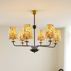 Multi-arm hanging chandelier featuring several floral conical shades on a dark metal frame