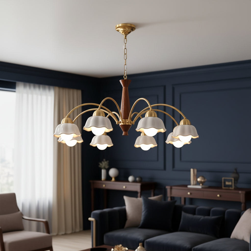 Downward-hanging chandelier with gold frame, brown stem, and six white scalloped shades.