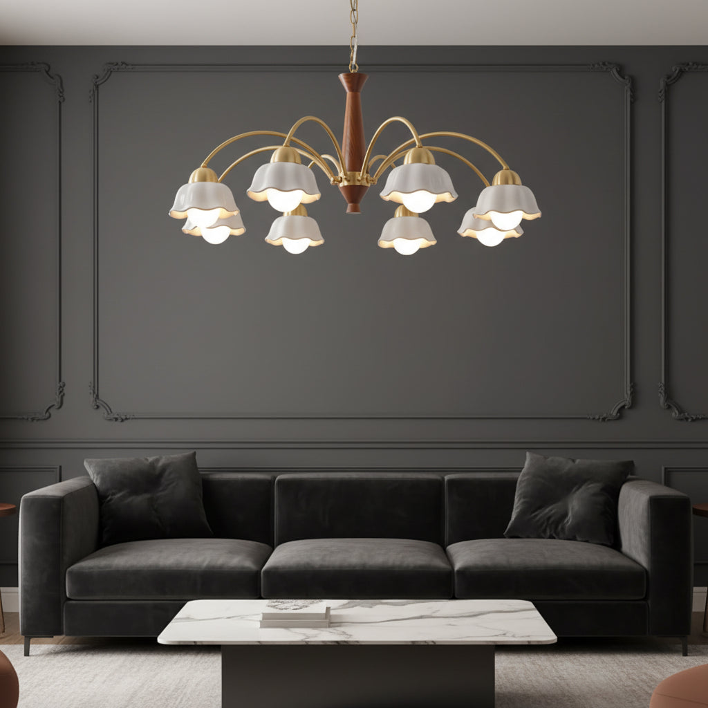 Multi-arm chandelier featuring gold curves, brown center, and white scalloped shades overhead.