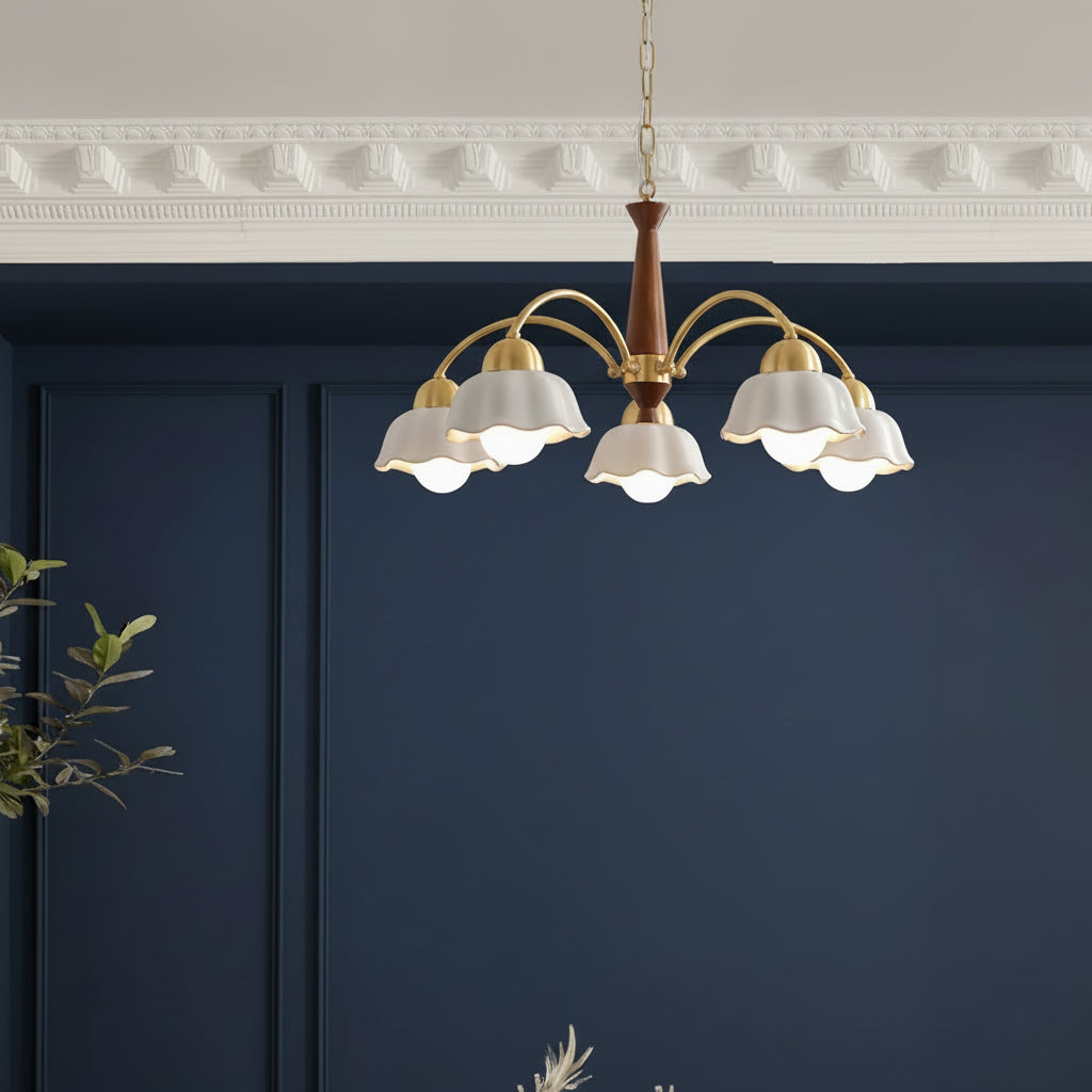 Gold-and-brown chandelier with multiple curved arms and white scalloped shades facing down.