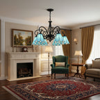 Victorian-style bell shade chandelier with black metal arms and blue stained-glass shades