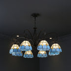 Black branch chandelier with multiple blue and amber stained-glass bell shades