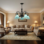 Black metal branch chandelier with 3 blue stained-glass bell shades and ornate central stem