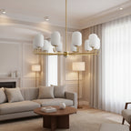 Hanging chandelier with frosted glass shades and gold metal frame in a living room