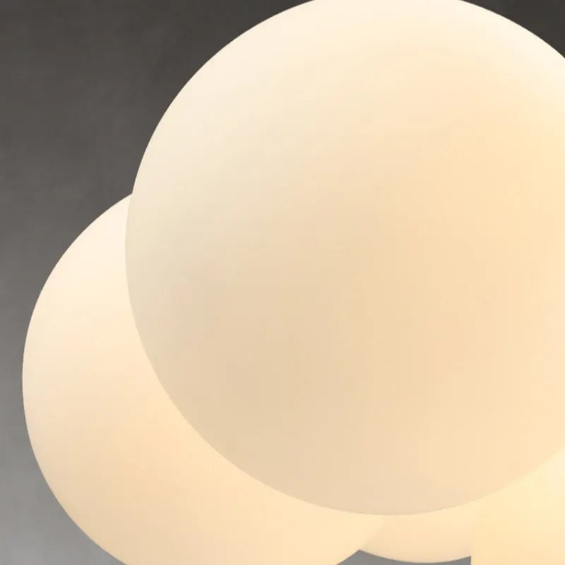Close-up of frosted white bubble glass globe on a hanging chandelier