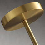 Close-up of brushed gold chandelier arm and canopy fixture hardware